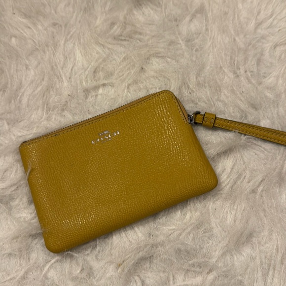 Coach Handbags - Coach Mustard Wristlet pre-owned.